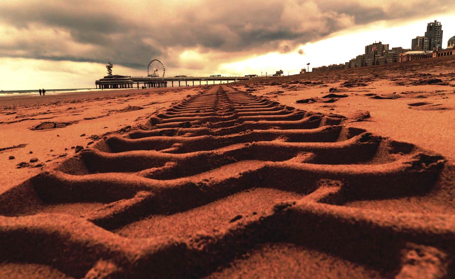 Allradfahrzeug fährt auf sandigem Strand